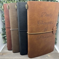 a leather journal with the words'daily thoughts and prayers'